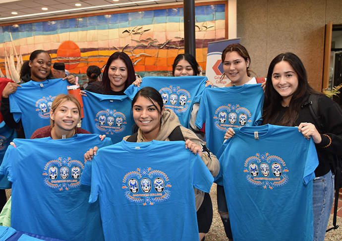 7 students pose at Hispanic Heritage Month Second Annual Fiesta with Fiesta shirts.