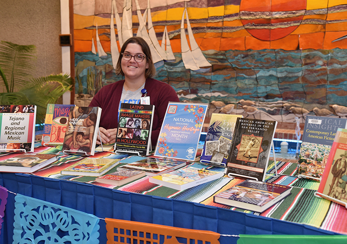 Person displaying HHM books.