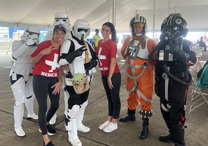 Nursing volunteers pose with characters from Star Wars movies.