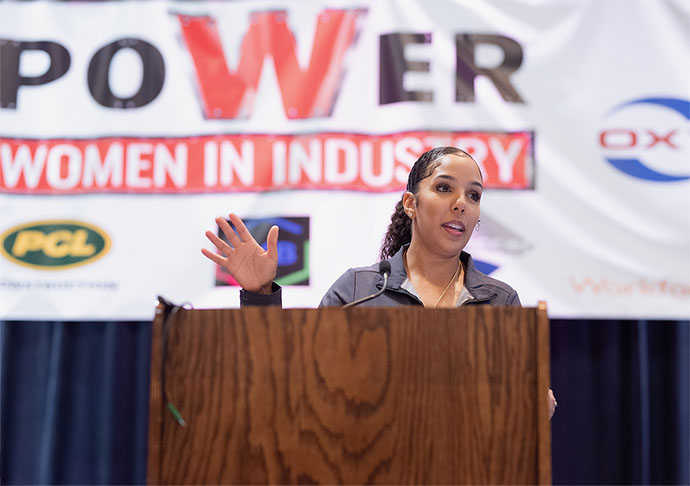 Woman at podium speaks to students at conference