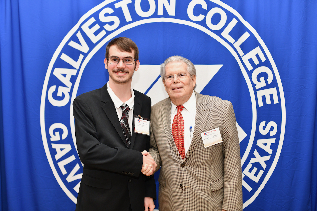 Dylan Davison shaking hands with C.G. Dibrell at the President's Reception. 